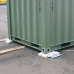 green-cargo-container-lifted-forklift